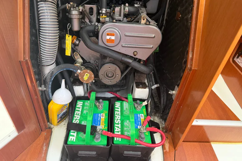 Slide: The Image of Engine compartment of a 2009 Beneteau Oceanis 31 sailboat with batteries and maintenance supplies. - 45