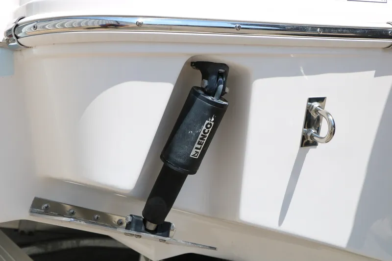 Slide: The Image of 2026 Robalo R230 Center Console boat detail with Lenco trim tab actuator. - 40