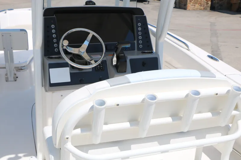 Slide: The Image of 2026 Robalo R230 Center Console boat dashboard with steering wheel and controls. - 14