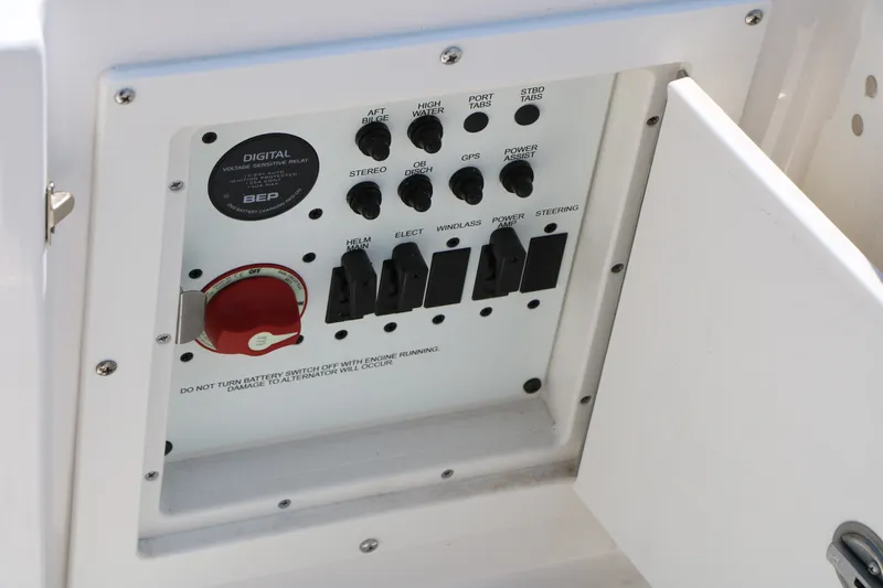 Slide: The Image of Control panel of 2026 Robalo R230 Center Console boat with switches and battery relay. - 38