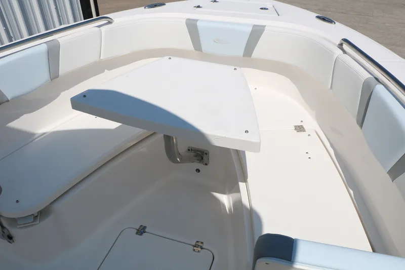 Slide: The Image of 2026 Robalo R230 Center Console boat interior with seating and table. - 25