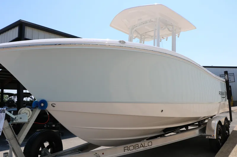 Slide: The Image of 2026 Robalo R230 Center Console boat on trailer, side view. - 7