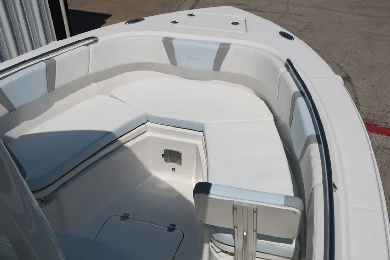 Slide: The Image of 2026 Robalo R230 Center Console boat interior with cushioned seating and storage. - 16