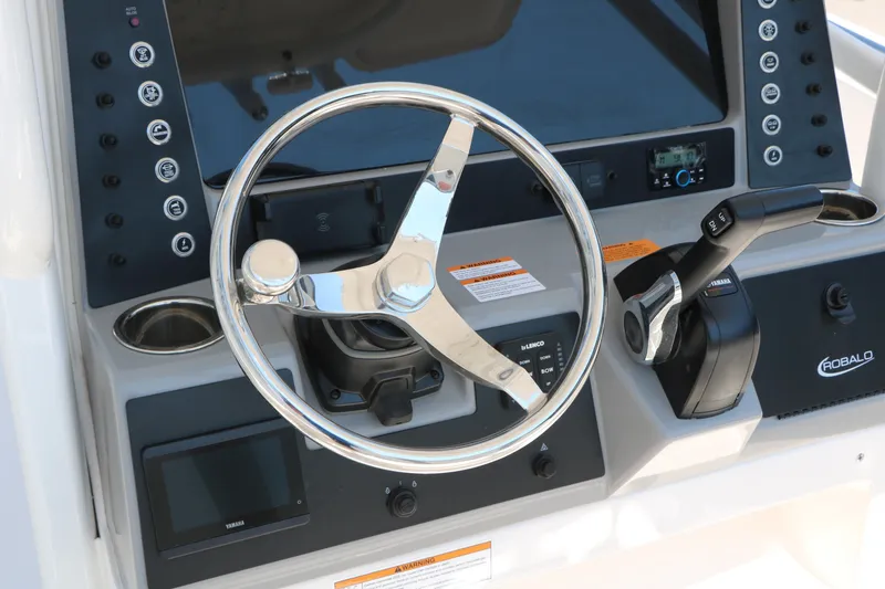 Slide: The Image of Steering console of 2026 Robalo R230 Center Console boat with controls and display. - 34