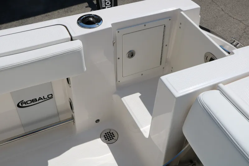 Slide: The Image of 2026 Robalo R230 Center Console boat interior with seating and storage compartment. - 37