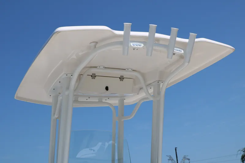 Slide: The Image of 2026 Robalo R230 Center Console T-top against clear blue sky. - 5