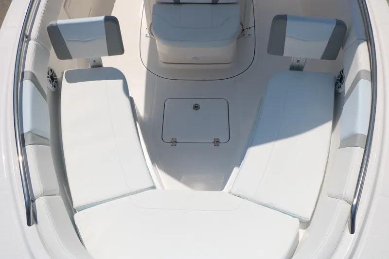 Slide: The Image of 2026 Robalo R230 Center Console boat interior with cushioned seating and storage compartment. - 18
