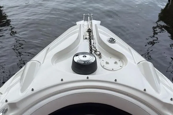 Slide: The Image of Bow of 2010 Larson LXi 288 boat on water, featuring anchor chain and deck details. - 13