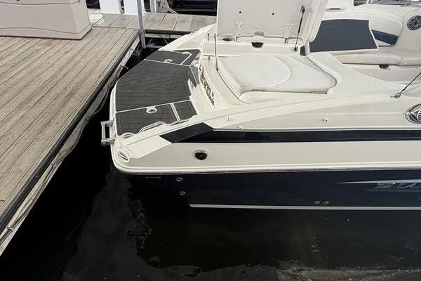 Slide: The Image of 2010 Larson LXi 288 boat docked, featuring sleek design and comfortable seating. - 16