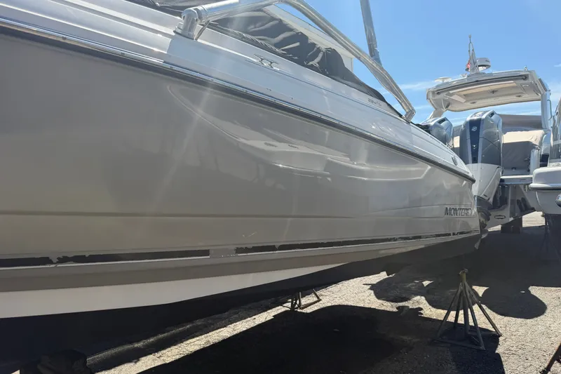 Slide: The Image of 2009 Monterey 234FS boat on stands, side view under bright sunlight. - 38