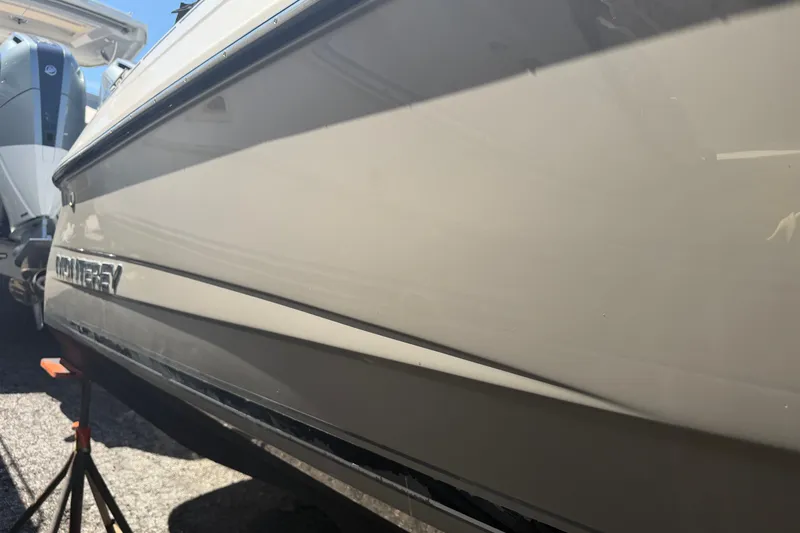 Slide: The Image of Side view of a 2009 Monterey 234FS boat on a stand, showcasing its sleek design. - 39