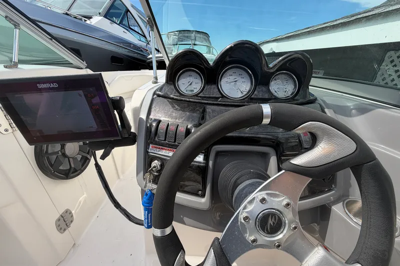 Slide: The Image of Steering console of a 2009 Monterey 234FS boat with gauges and navigation system. - 34