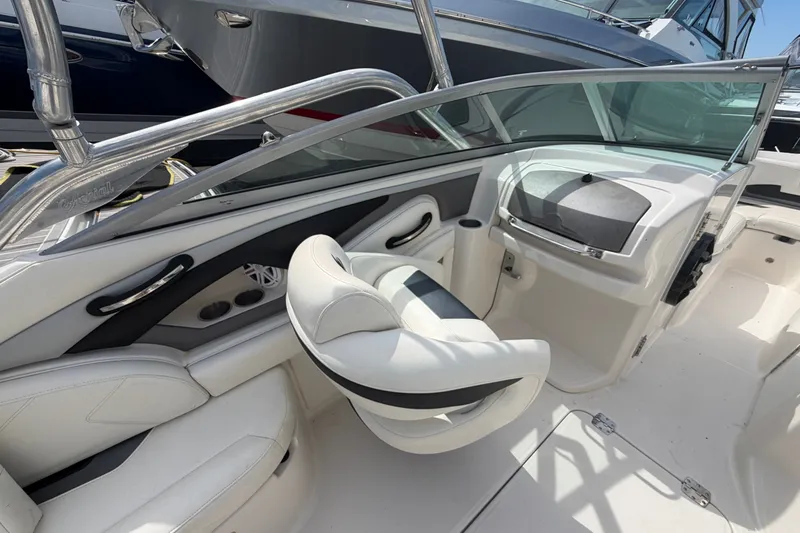 Slide: The Image of Interior of a 2009 Monterey 234FS boat, featuring white seating and sleek design. - 22