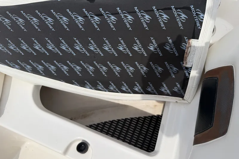 Slide: The Image of 2009 Monterey 234FS boat seat with branded upholstery and white trim. - 25
