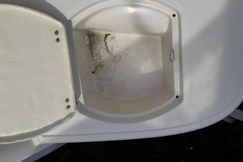 Slide: The Image of Open storage compartment on a 2009 Monterey 234FS boat, showing interior details. - 17