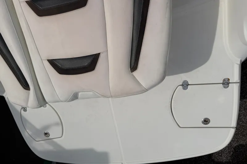 Slide: The Image of 2009 Monterey 234FS boat seat and deck, featuring white and black upholstery. - 13
