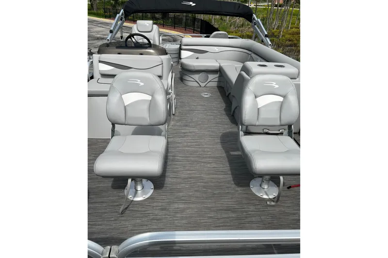 Slide: The Image of 2023 Bennington 20 SF pontoon boat interior with gray seating and steering console. - 3