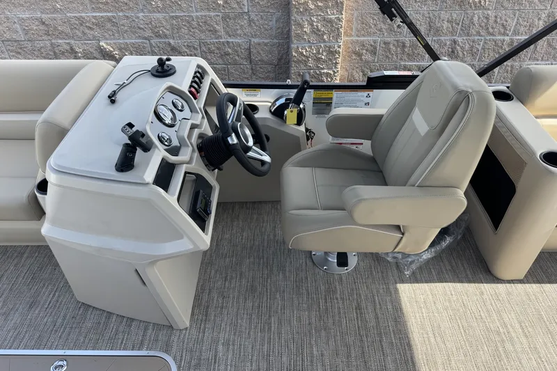 Slide: The Image of 2027 Godfrey Xperience 23' Split Bench boat interior with steering console and captain's chair. - 13