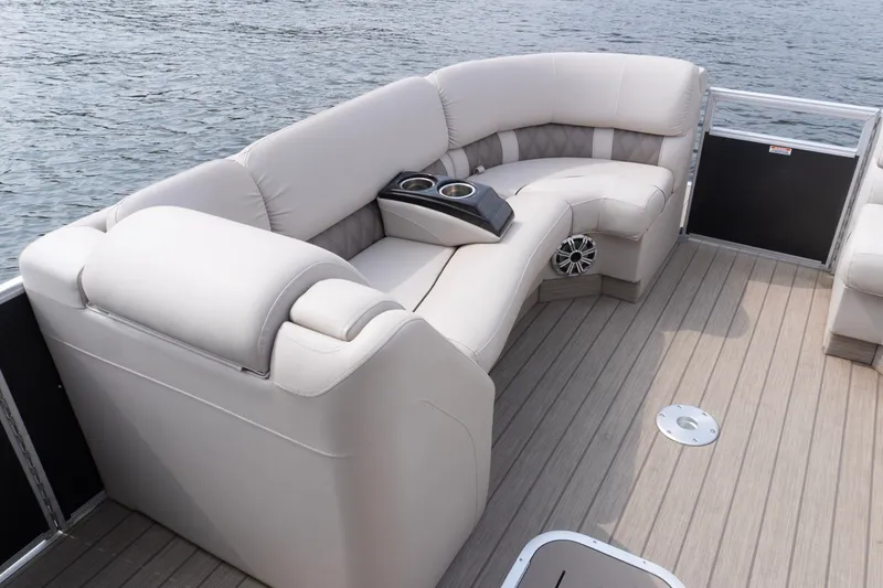 Slide: The Image of Luxurious seating on a 2017 Bennington R25 pontoon boat, featuring plush upholstery and cup holders. - 11