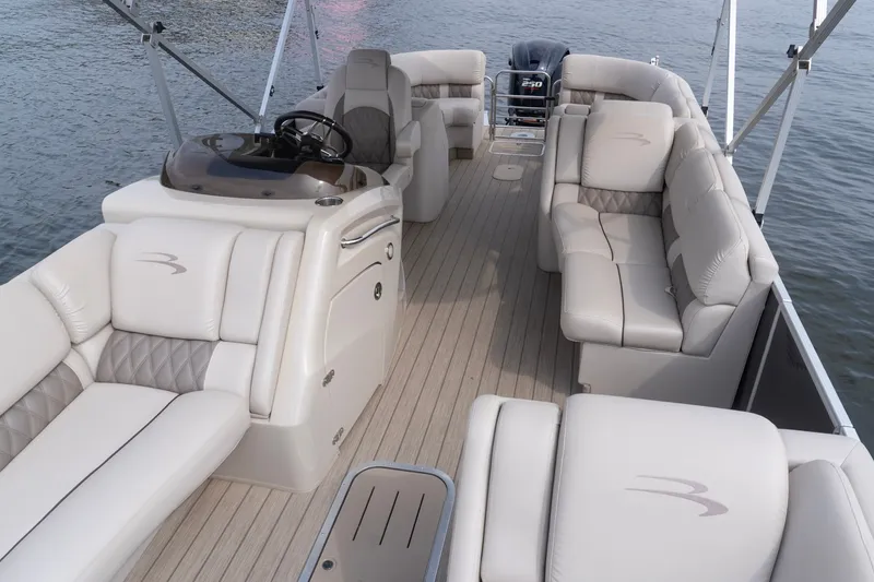 Slide: The Image of Luxurious 2017 Bennington R25 pontoon boat interior with plush seating and modern helm. - 15