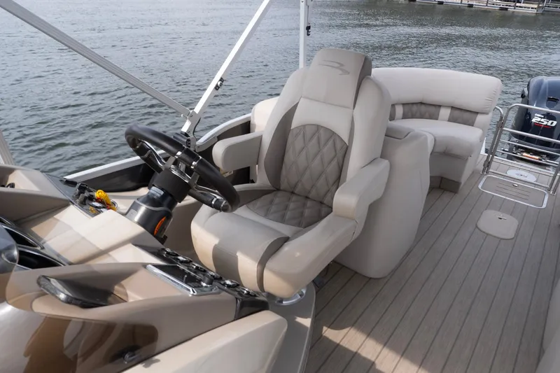 Slide: The Image of Luxurious interior of a 2017 Bennington R25 boat with plush seating and steering wheel. - 21