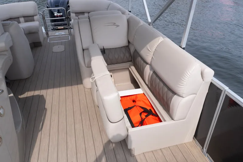 Slide: The Image of 2017 Bennington R25 boat interior with storage compartment and life jacket. - 17