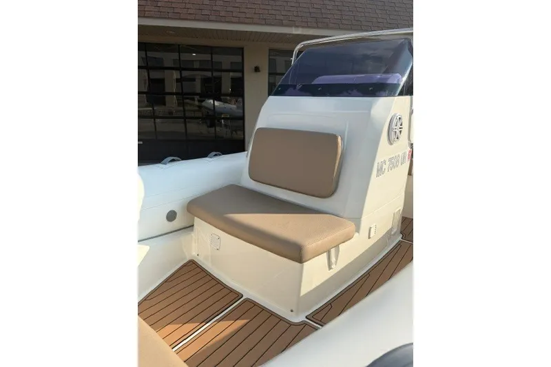 Slide: The Image of 2020 Brig Eagle 6.7 boat interior with cushioned seating and wooden flooring. - 3