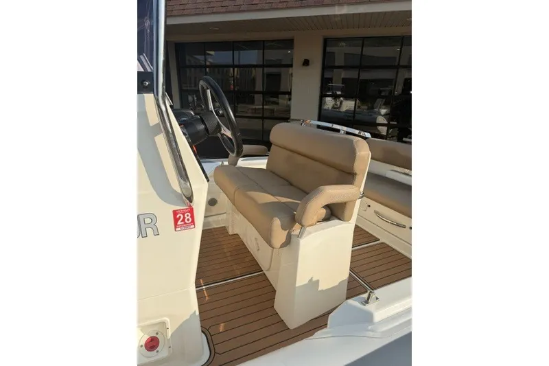 Slide: The Image of 2020 Brig Eagle 6.7 boat interior with tan seating and steering wheel. - 4