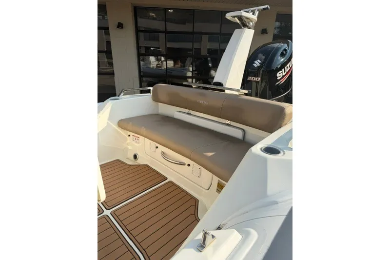 Slide: The Image of 2020 Brig Eagle 6.7 boat interior with seating and Suzuki outboard motor. - 7