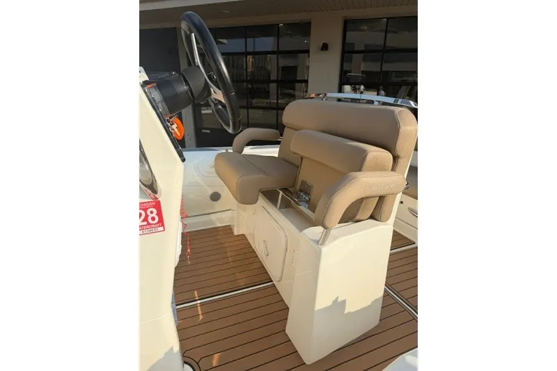 Slide: The Image of 2020 Brig Eagle 6.7 boat interior with beige seating and steering wheel. - 5