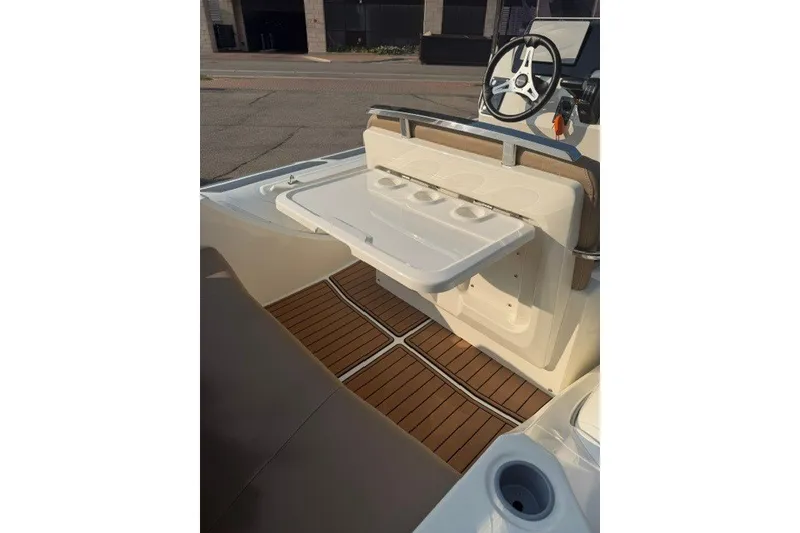 Slide: The Image of 2020 Brig Eagle 6.7 boat interior with foldable table and teak flooring. - 8