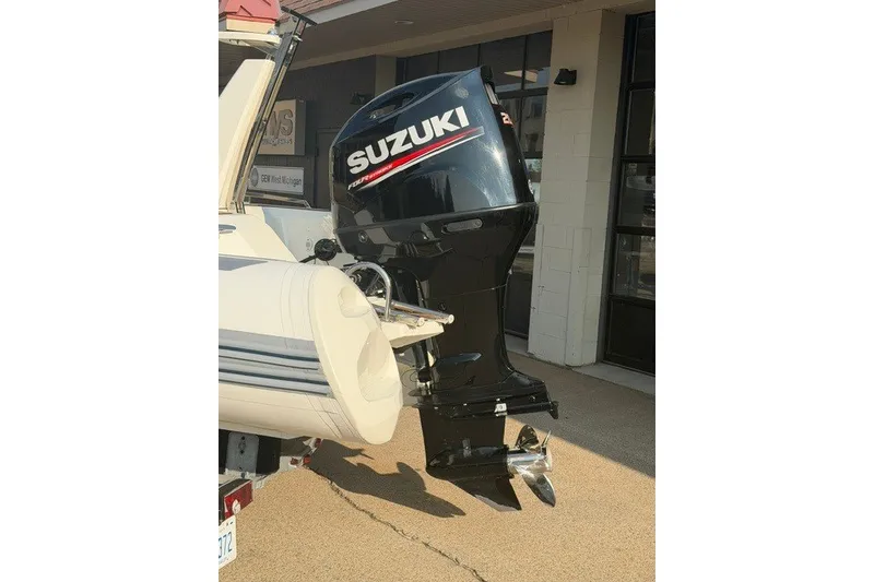 Slide: The Image of 2020 Brig Eagle 6.7 boat with Suzuki outboard motor displayed outdoors. - 9