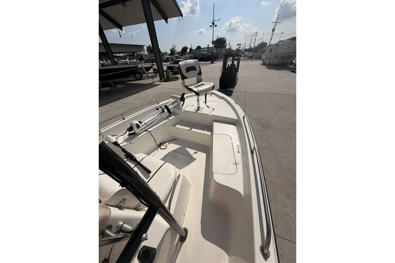 Slide: The Image of 2000 Century 2101 Bay Boat interior view at a marina under clear skies. - 18
