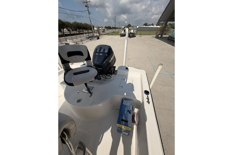 Slide: The Image of Century 2101 Bay Boat 2000 model with Yamaha engine, docked outdoors under a cloudy sky. - 14