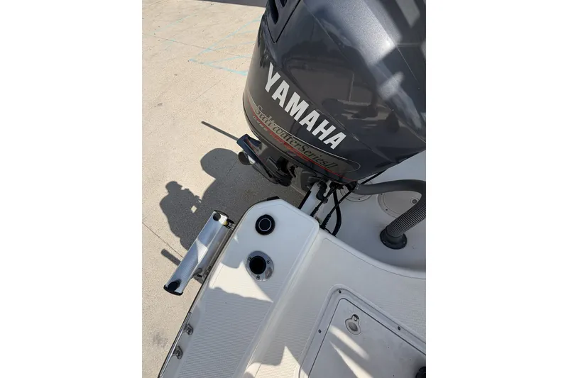 Slide: The Image of Century 2101 Bay Boat 2000 with Yamaha outboard motor, docked on a sunny day. - 16
