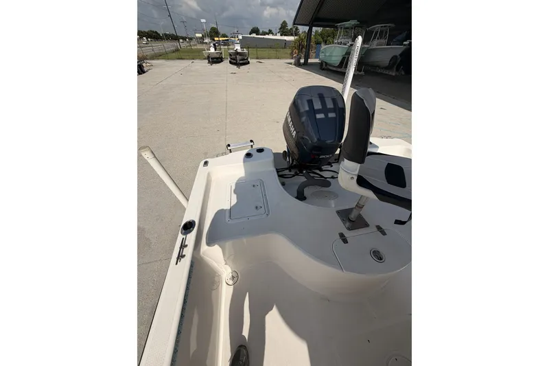 Slide: The Image of Century 2101 Bay Boat 2000 model with Yamaha engine, parked outdoors. - 15
