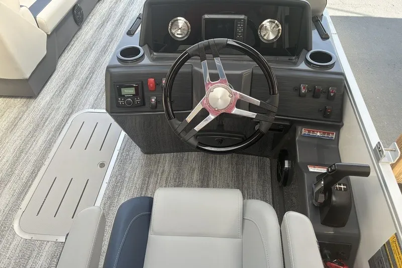 Slide: The Image of 2027 Bennington 22 SSR boat helm with steering wheel, controls, and dashboard features. - 2