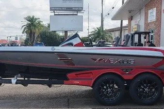 Slide: The Image of 2026 Vexus VXs20 boat on trailer, sleek design, red and gray color scheme. - 2