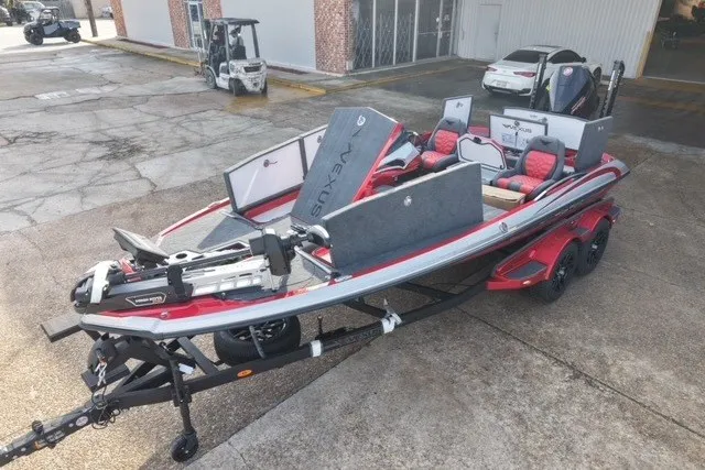 Slide: The Image of 2026 Vexus VXs20 boat on trailer, featuring red accents and advanced equipment, parked outdoors. - 7