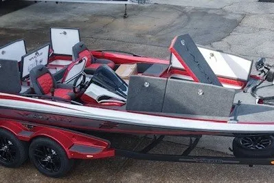 Slide: The Image of 2026 Vexus VXs20 boat with red and gray interior, open storage compartments, and dual-axle trailer. - 9