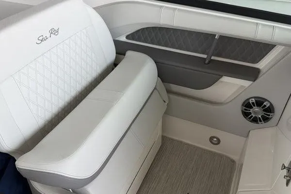 Slide: The Image of 2022 Sea Ray SLX 310 interior with white leather seating and speaker detail. - 14