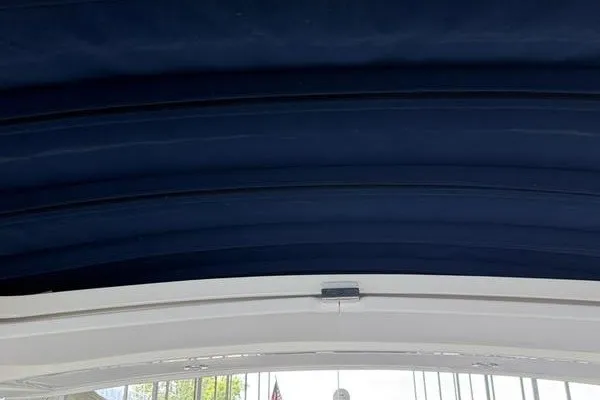 Slide: The Image of 2022 Sea Ray SLX 310 boat canopy, showcasing sleek navy blue design. - 16