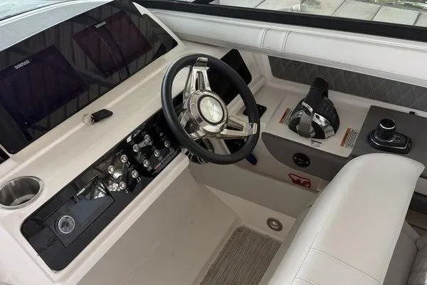 Slide: The Image of 2022 Sea Ray SLX 310 boat cockpit with modern steering and control panel. - 4