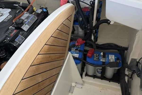 Slide: The Image of Engine compartment of 2022 Sea Ray SLX 310 boat with batteries and wooden panel. - 8