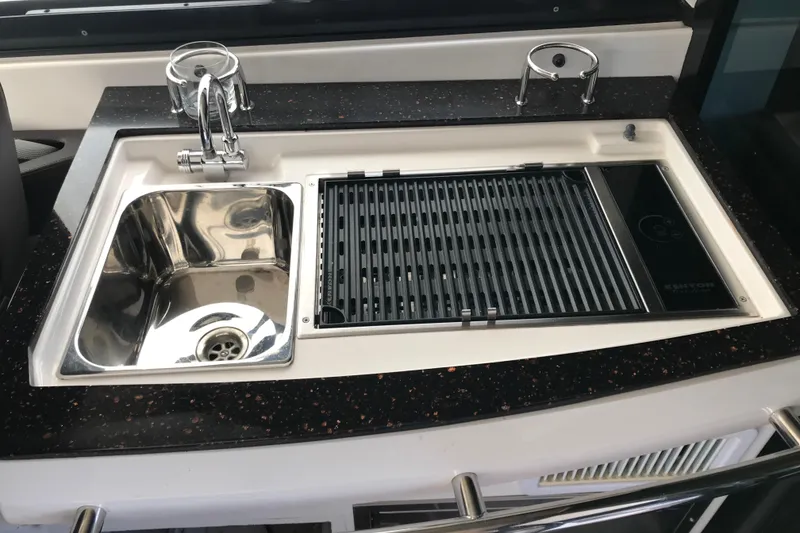 Slide: The Image of Luxurious 2013 Regal 42 Sport Coupe yacht kitchen with sink and grill. - 14