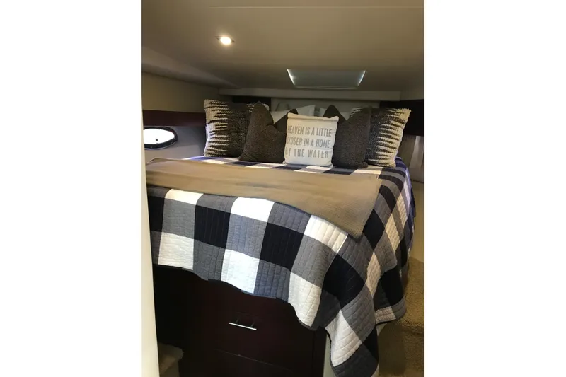 Slide: The Image of Cozy bedroom in 2013 Regal 42 Sport Coupe with checkered bedding and decorative pillows. - 32