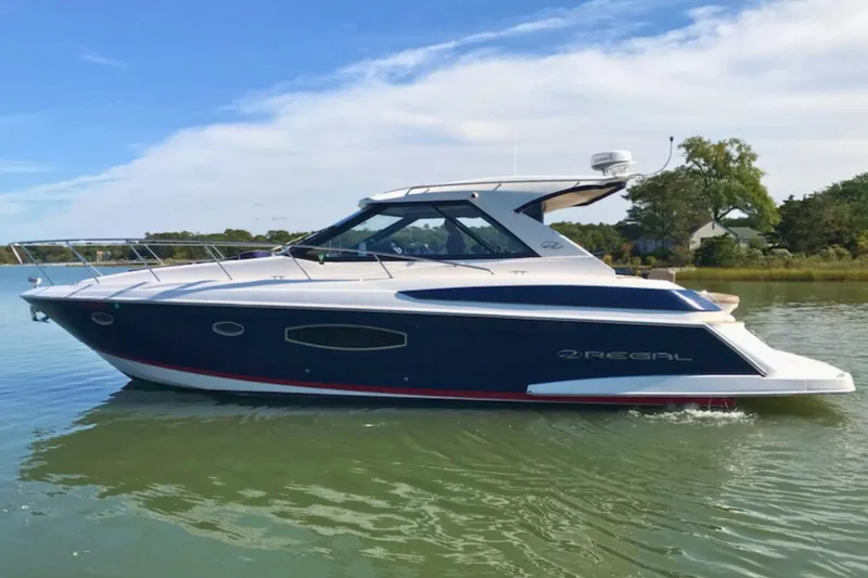 The Image of 2013 Regal 42 Sport Coupe yacht cruising on calm waters under a clear sky. - 0