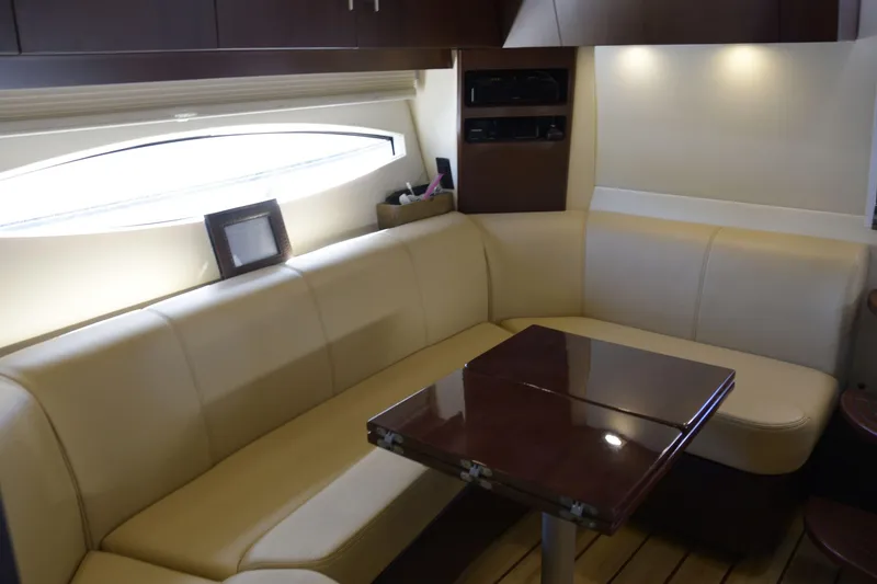 Slide: The Image of Luxurious interior of 2013 Regal 42 Sport Coupe with cream leather seating and wooden table. - 25