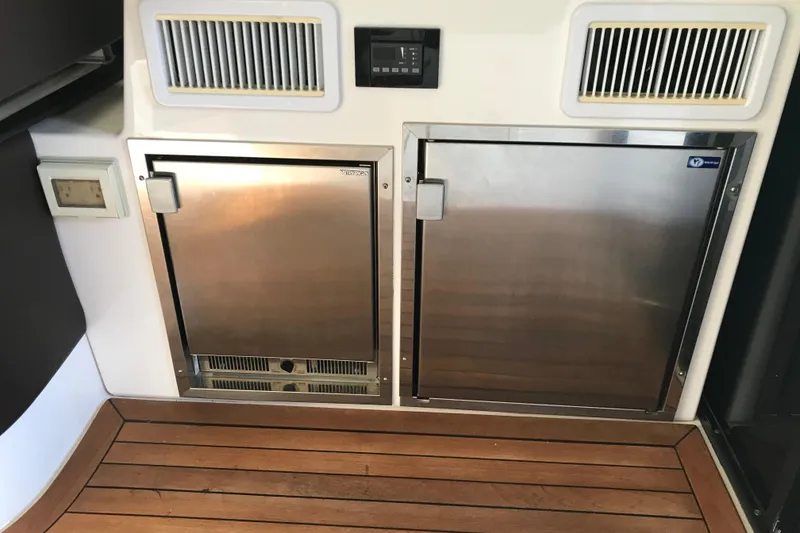 Slide: The Image of Stainless steel appliances on 2013 Regal 42 Sport Coupe yacht with teak flooring. - 15