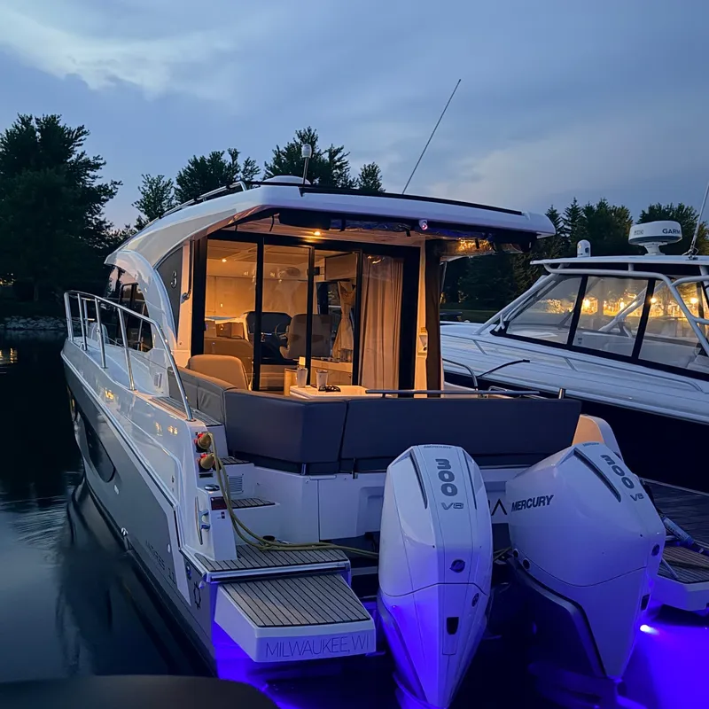 Slide: The Image of The 2025 Beneteau Antares 11 is docked, illuminated, featuring two Mercury engines. - 41